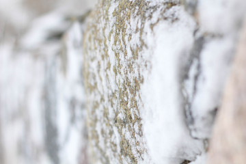 Snow drifts on a stone fence.  Perfect for home. Stock photo. White and grey. Winter dayPerfect for home. Stock photo.