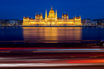 long exposure picture of Hungarian Parliament in Budapest with Danube at dawn