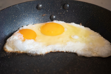 Tasty over easy fried egg in frying pan