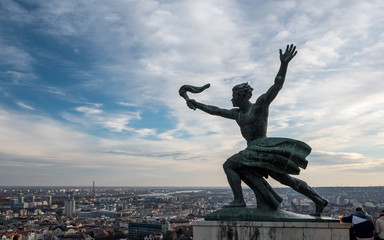 flame of freedom statue on Gellert Hill with view over Budapest on a beautiful winter day
