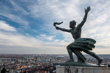 flame of freedom statue on Gellert Hill with view over Budapest on a beautiful winter day © schame87