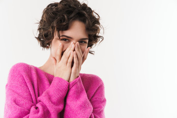 Image of joyful beautiful woman smiling and covering her face