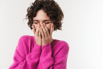 Image of joyful beautiful woman smiling and covering her face