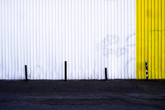 White And Yellow Wall With Painted Over Graffiti