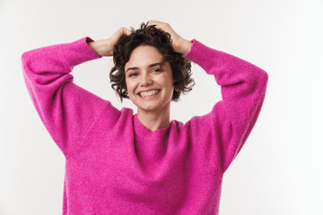 Image of cheerful young woman grabbing her head and smiling