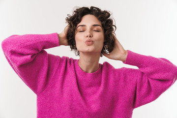 Image of happy caucasian woman making kiss lips and grabbing her head
