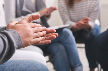 Closeup of people applouding to each other at psychotherapy group meeting