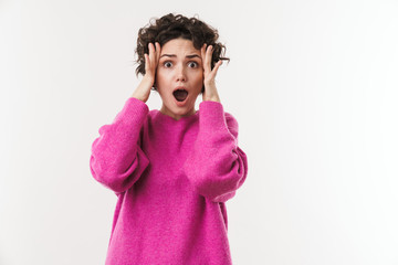 Image of young shocked woman expressing surprise and grabbing her head