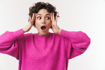 Image of young shocked woman expressing surprise and grabbing her head