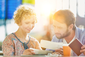 Mature couple looking at their boarding pass in airport