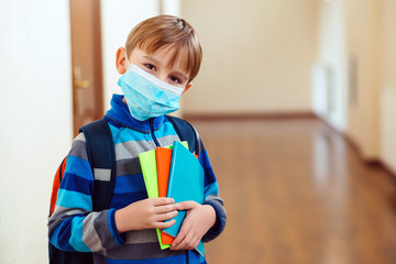 Schoolboy with protect mask on face. Face mask for protection coronavirus outbreak. Medicine...