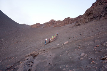 group of hikers climbs on Stromboli volcano from Ginostra