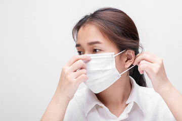 Young woman with face mask isolated on white background to prevent coronavirus & PM 2.5 air pollution, Woman demonstrate how to wear virus protective face mask.