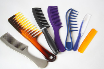 A set of plastic hair combs. White background.