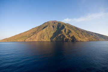View of the Stromboli volcano over the sea with blue sky, Aeolian Islands, Messina, Sicily, Italy