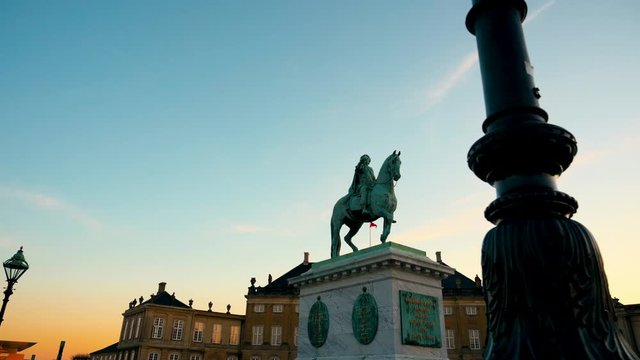 Walking around The equestrian Bronze cast equestrian statue of King Frederik V mounted on a marble plinth on Amalienborg square complex of rococo palaces & museum in Copenhagen, Denmark.