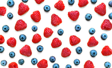 Colorful fruit pattern of raspberries and blueberries isolated on white background. Flat lay