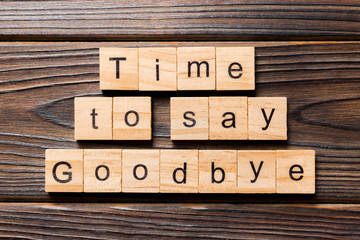 Time to say goodbye word written on wood block. Time to say goodbye text on wooden table for your...