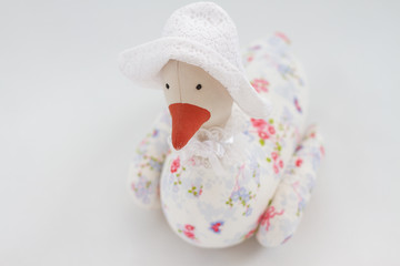 portrait of a handmade duck in a hat on a white background