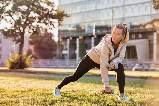 Young attractive woman stretching in park