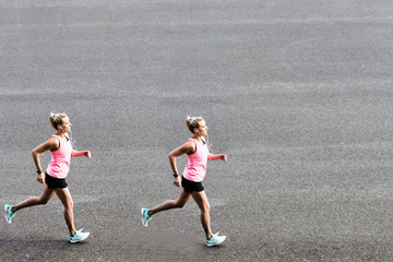 Portrait of young attractive woman running in park