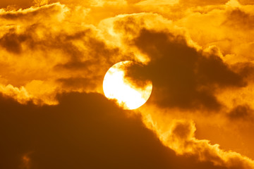 Hot summer season on big sun on sky and clouds