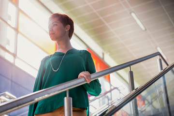 Portrait of young attractive businesswoman walking down stairs