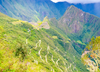 Machu Picchu in Peru from unusual angle with view of serpentine road