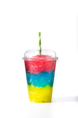 Colorful slushie of differents flavors with straw in plastic cup isolated on white background