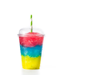 Colorful slushie of differents flavors with straw in plastic cup isolated on white background. Copy...
