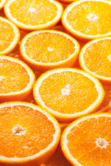 Background from fresh orange slices. Side view.