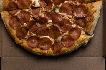 Food ingredients and spices for cooking mushrooms, tomatoes, cheese, onion, oil, pepper, salt, basil, olive and delicious italian pizza on black concrete background. Copyspace. Top view. Banner