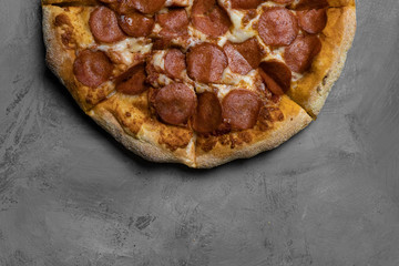 Food ingredients and spices for cooking mushrooms, tomatoes, cheese, onion, oil, pepper, salt, basil, olive and delicious italian pizza on black concrete background. Copyspace. Top view. Banner