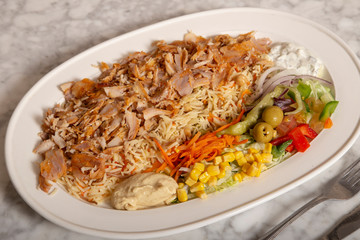 Turkish food dish. Rice with meat Chicken kebab, hummus fries and salad.