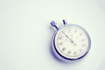 Retro mechanical stopwatch on a white background.