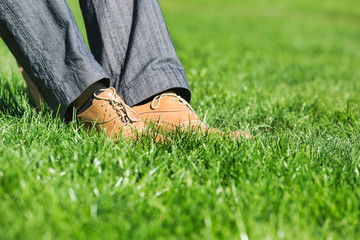 Close up of businessman foot on the grass