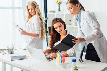 smart and sexy nurses in white coats working in clinic