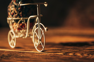 Fototapeta na wymiar Vintage Easter egg on bike. Bicycle retro photo on wooden background.