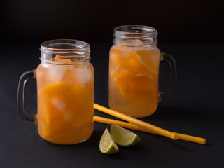 cooling drink tangerine juice with ice on the kitchen table.