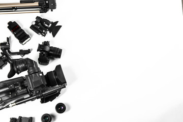 Flat lay composition with video camera and other equipment on white background. Space for text