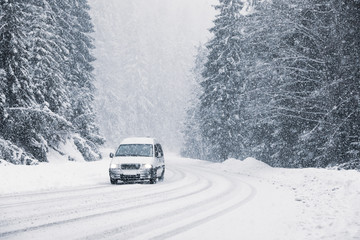 Snowy country road with modern car on winter day