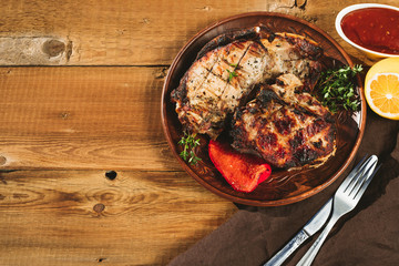 pork steak on a wooden background in a platepork steak on a wooden background in a plate