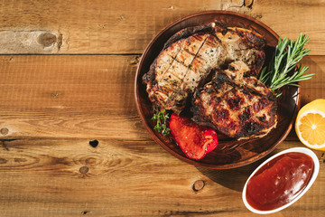 pork steak on a wooden background in a platepork steak on a wooden background in a plate
