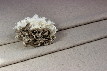 Rose from pieces of flax on a piece of fabric