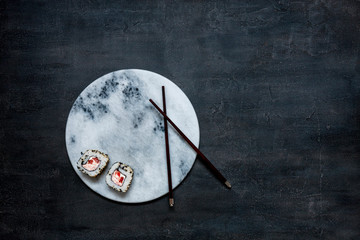 Japanese crab meat mousse sauce on marble stone board  with chopsticks. Top view, close up on black concrete background