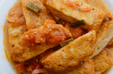 Fried fishcakes slices with tomato sauce
