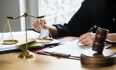 justice and law concept. Female judge in a courtroom on wooden table and Counselor or Male lawyer...
