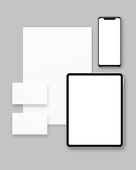 Blank paper, business cards, tablet, smartphone isolated on grey background. Stationery mockup vector. Branding stationery mockup scene. Realistic vector illustration. 