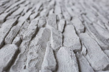 Surface white wall of stone wall gray tones for use as background. selective focus