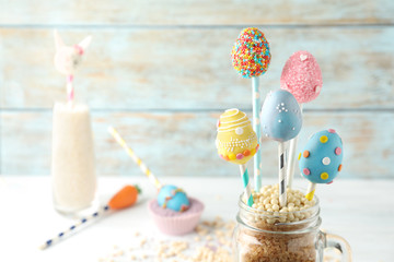 Egg shaped cake pops on light table, space for text. Easter celebration